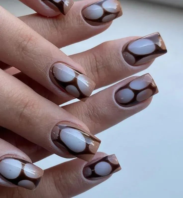 Unique brown and white swirled geometric nail art from Nail Shadow.